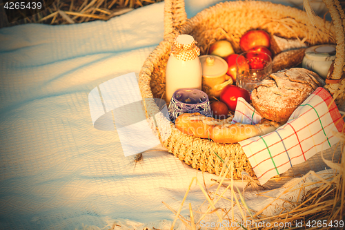 Image of Bread, milk and apples in a basket.