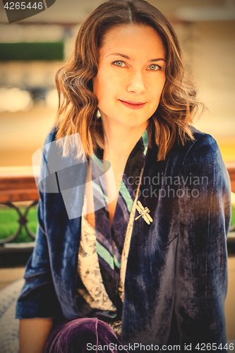 Image of woman in purple jacket with dragonfly brooch