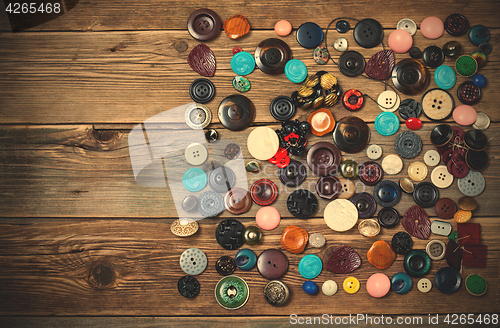 Image of Old buttons on the wooden boards