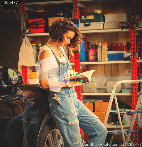 Image of woman car mechanic in the garage