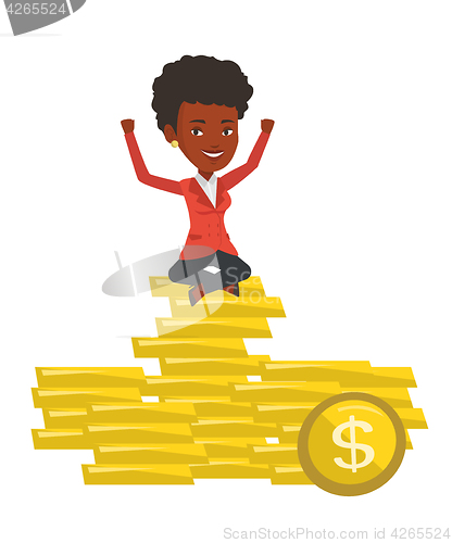 Image of Happy businesswoman sitting on golden coins.