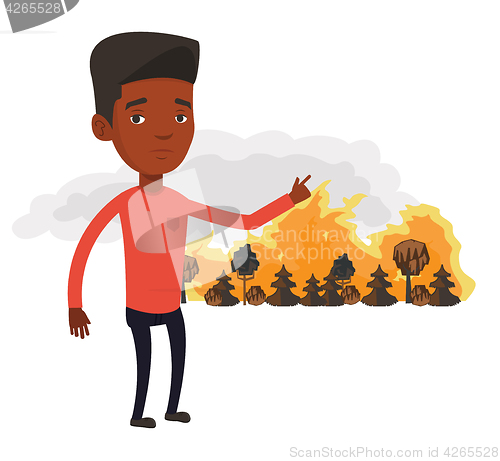 Image of Man standing on background of wildfire.