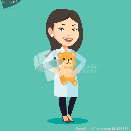 Image of Pediatrician doctor holding teddy bear.