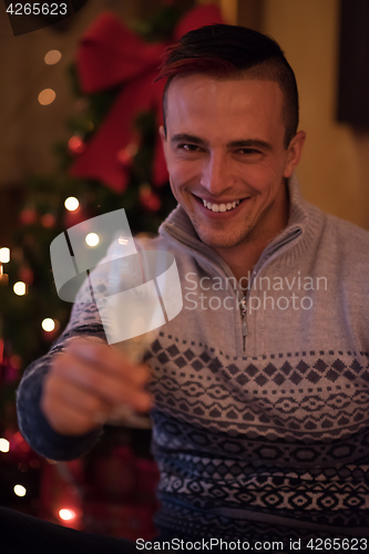 Image of Happy young man with a glass of champagne