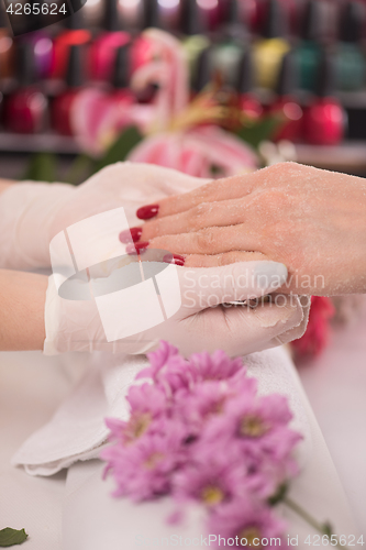 Image of Woman hands receiving a manicure