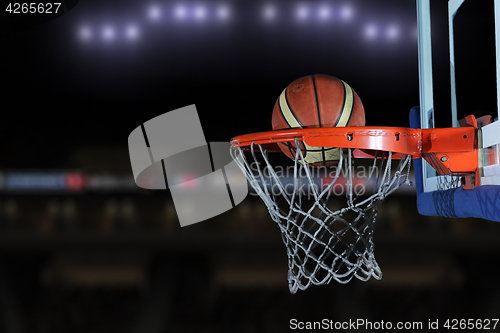 Image of basketball ball and net on grey background