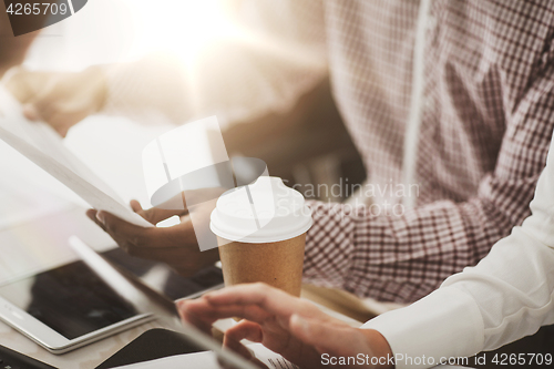 Image of business team with papers and coffee at office