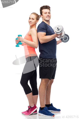 Image of sportive man and woman with dumbbells