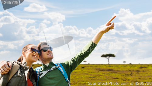 Image of happy couple with backpacks traveling in africa