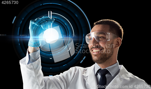 Image of smiling scientist in goggles with test tube