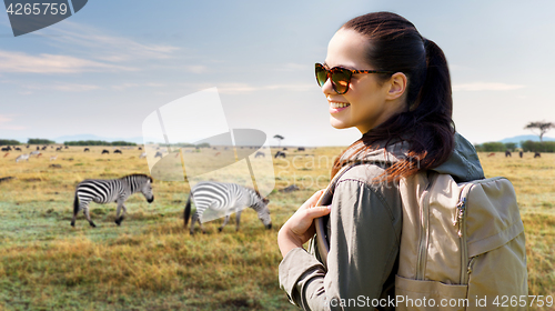 Image of happy woman with backpack traveling in africa