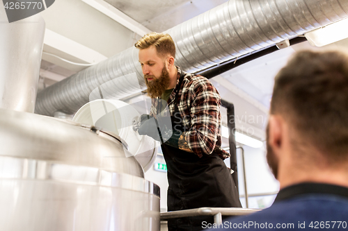 Image of men working at craft brewery or beer plant