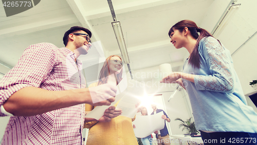 Image of creative team on coffee break talking at office