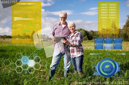 Image of happy senior couple with tablet pc at summer farm