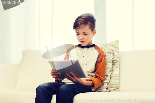 Image of boy with tablet computer at home