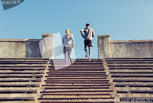 Image of couple running upstairs on stadium