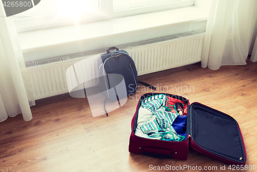 Image of close up of travel bag with clothes and backpack