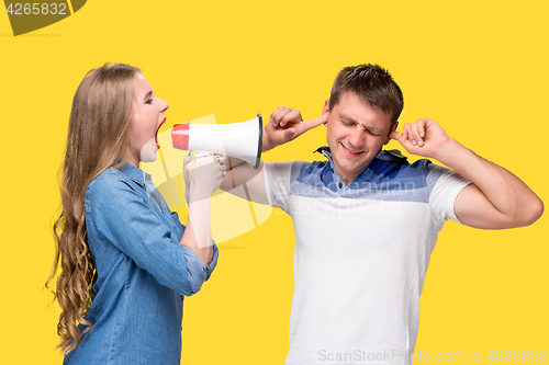 Image of Woman shouting in megaphones at each other