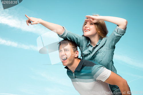 Image of Young couple smiling under blue sky