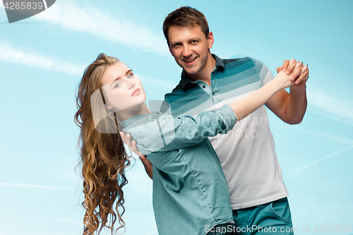 Image of Young couple smiling under blue sky