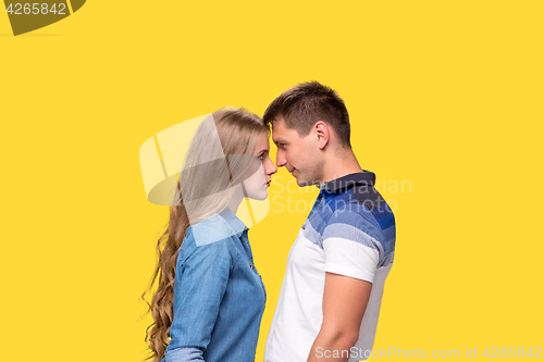 Image of Portrait of a young couple standing against gray background