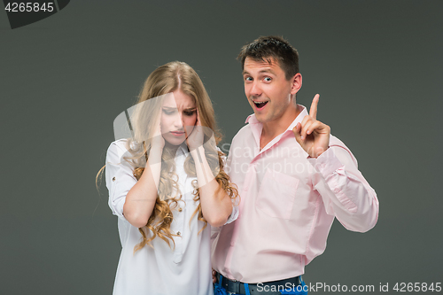 Image of The young couple with different emotions during conflict