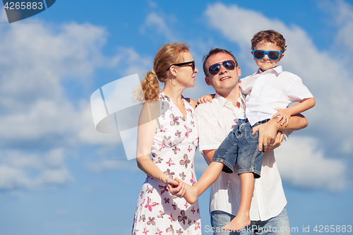 Image of Happy family walking on the beach at the day time.