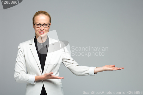 Image of Business woman showing hand sign to side.
