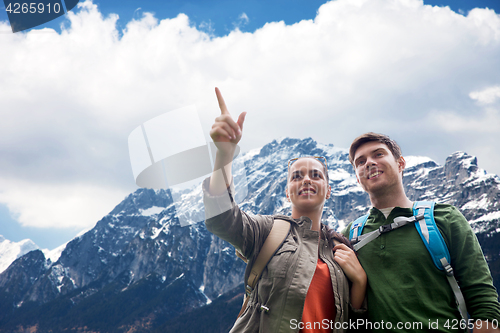 Image of happy couple with backpacks traveling in highlands