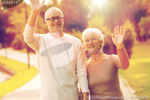 Image of senior couple hugging in city park