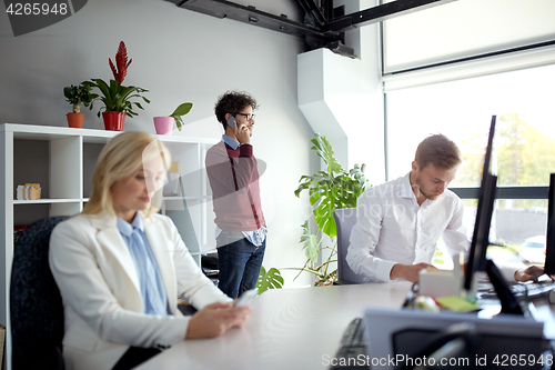 Image of business team with smartphones at office