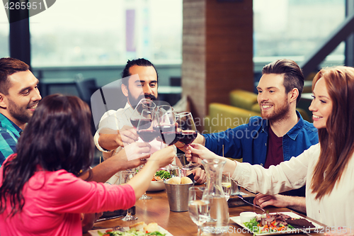 Image of friends dining and drinking wine at restaurant