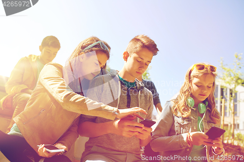 Image of teenage friends with smartphone and headphones