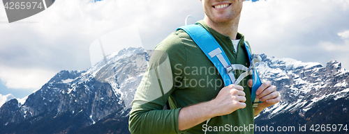 Image of close up of happy man with backpack traveling