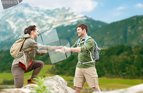 Image of happy couple with backpacks traveling in highlands