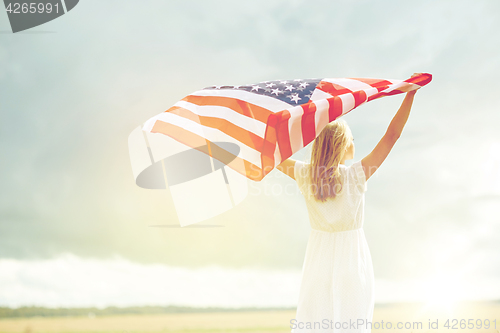 Image of happy woman with american flag on cereal field