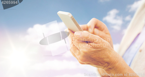 Image of close up of senior woman with smartphone texting