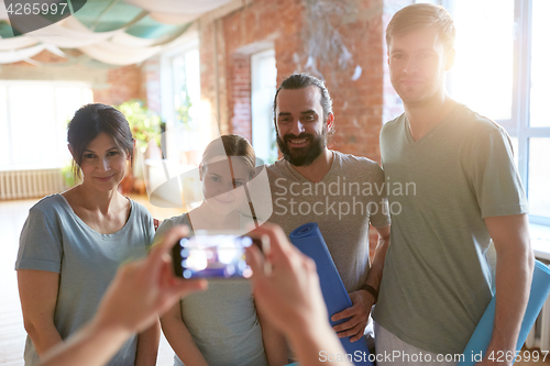 Image of happy people at yoga studio or gym photographing