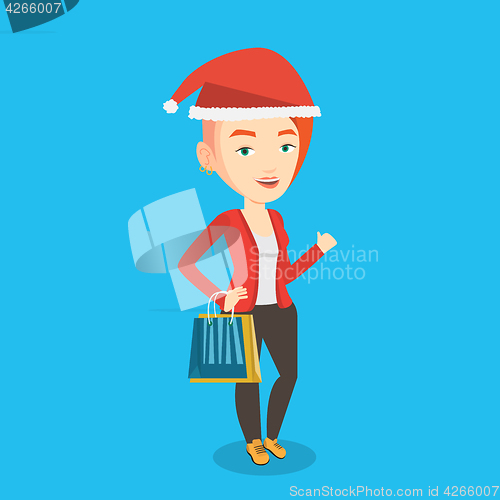 Image of Woman in santa hat shopping for christmas gifts.