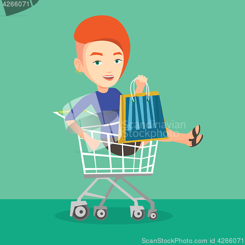 Image of Happy woman riding by shopping trolley.