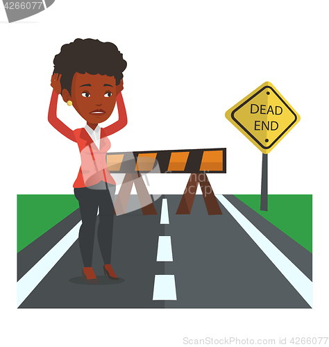 Image of Business woman looking at road sign dead end.