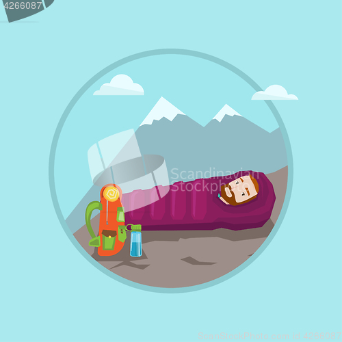 Image of Man lying in sleeping bag in the mountains.