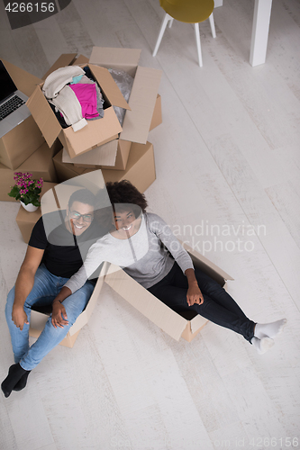 Image of African American couple  playing with packing material