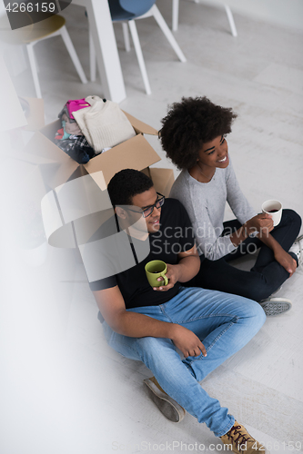 Image of African American couple relaxing in new house