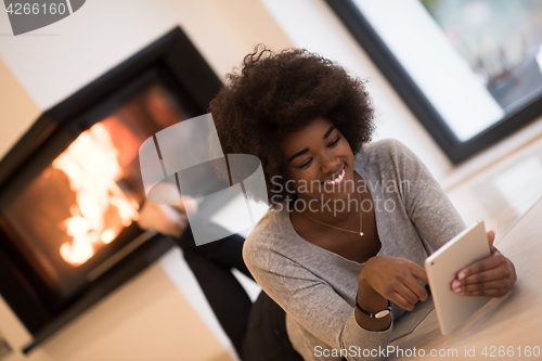 Image of black women using tablet computer on the floor