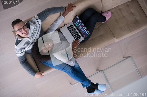 Image of happy multiethnic couple relaxes in the living room