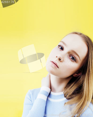 Image of lifestyle people concept: pretty young school teenage girl having fun happy smiling on yellow background