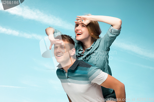 Image of Young couple smiling under blue sky