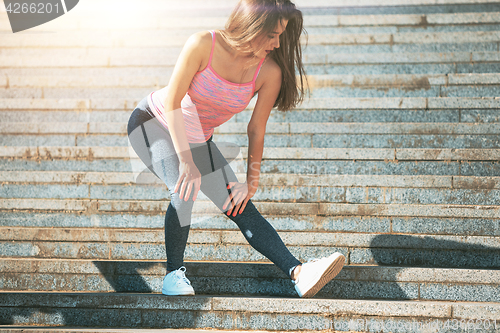 Image of Fit fitness woman doing stretching exercises outdoors at park