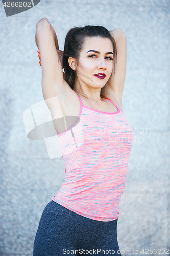 Image of Fit fitness woman doing stretching exercises outdoors at park